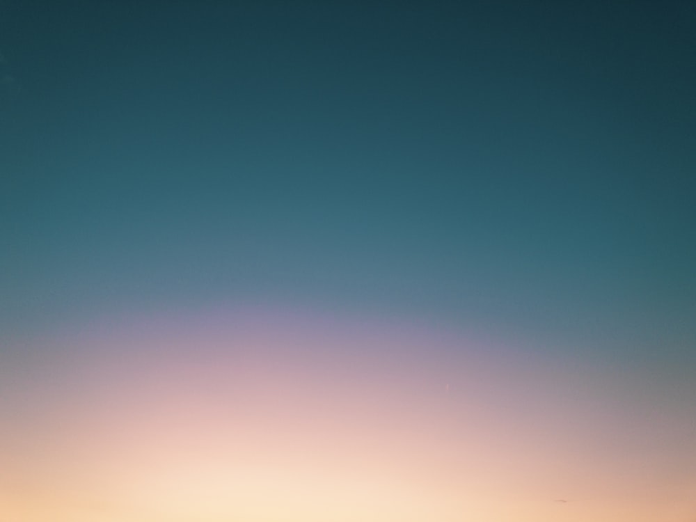 a couple of people standing on top of a beach