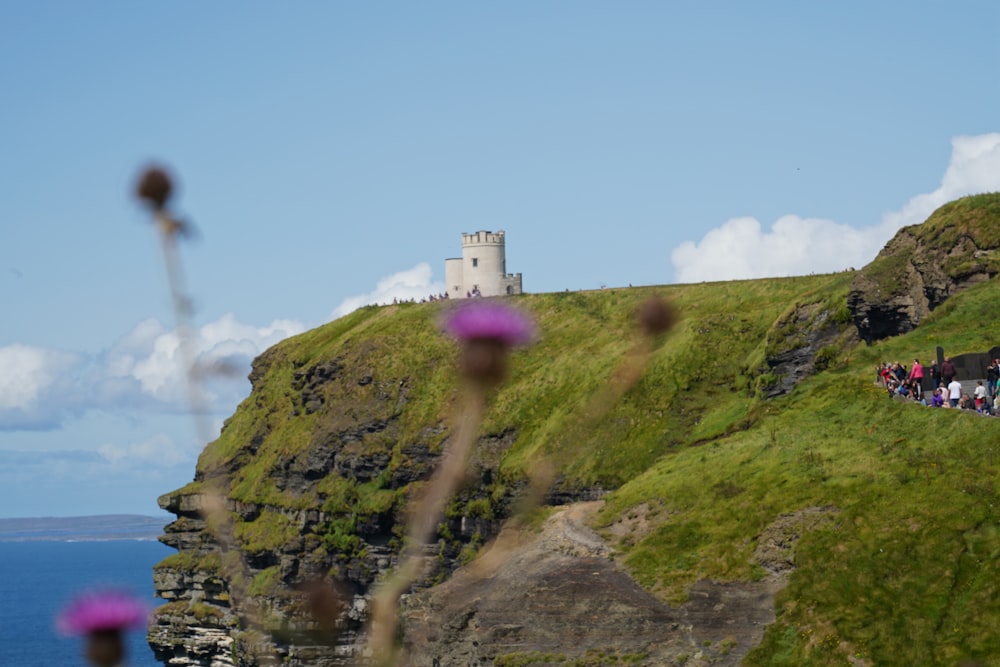 grey concrete tower at the cliff during daytime