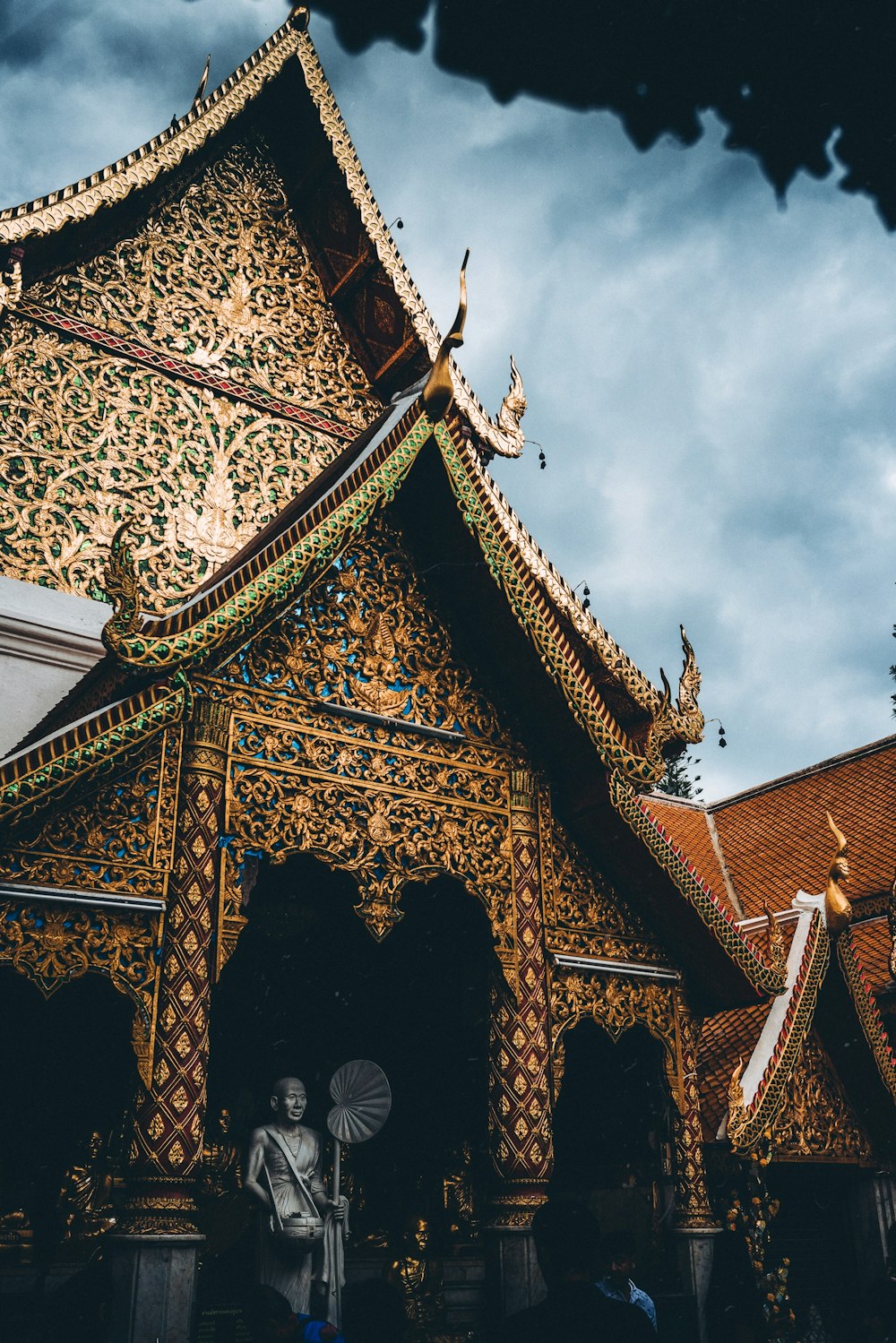 brown and green temple under blue and white skies