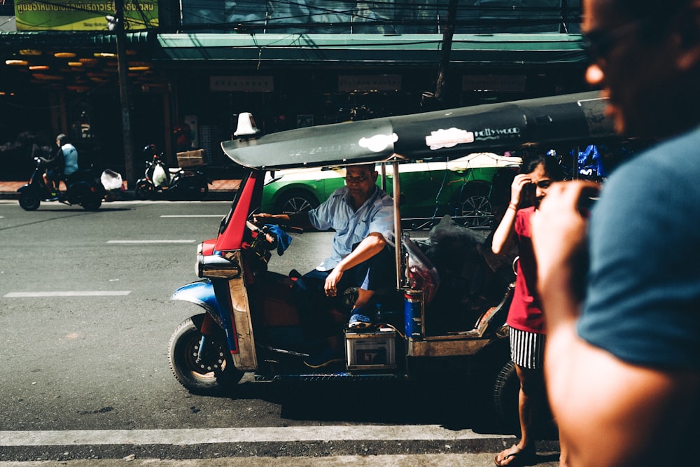 unknown person riding on brown and black auto rickshaw