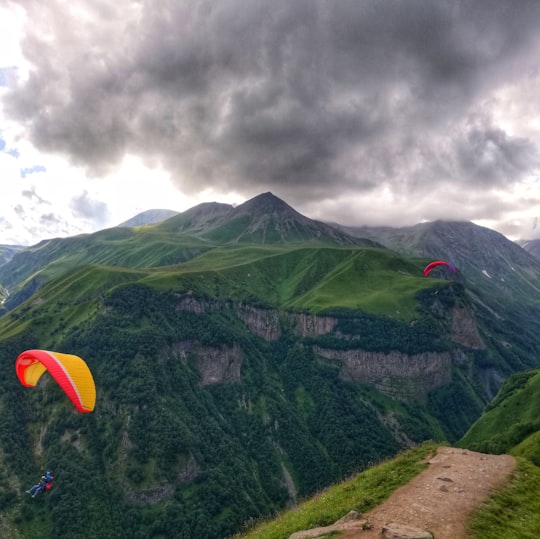 two person doing paragliding over the mountain in Gudauri Recreational Area Georgia
