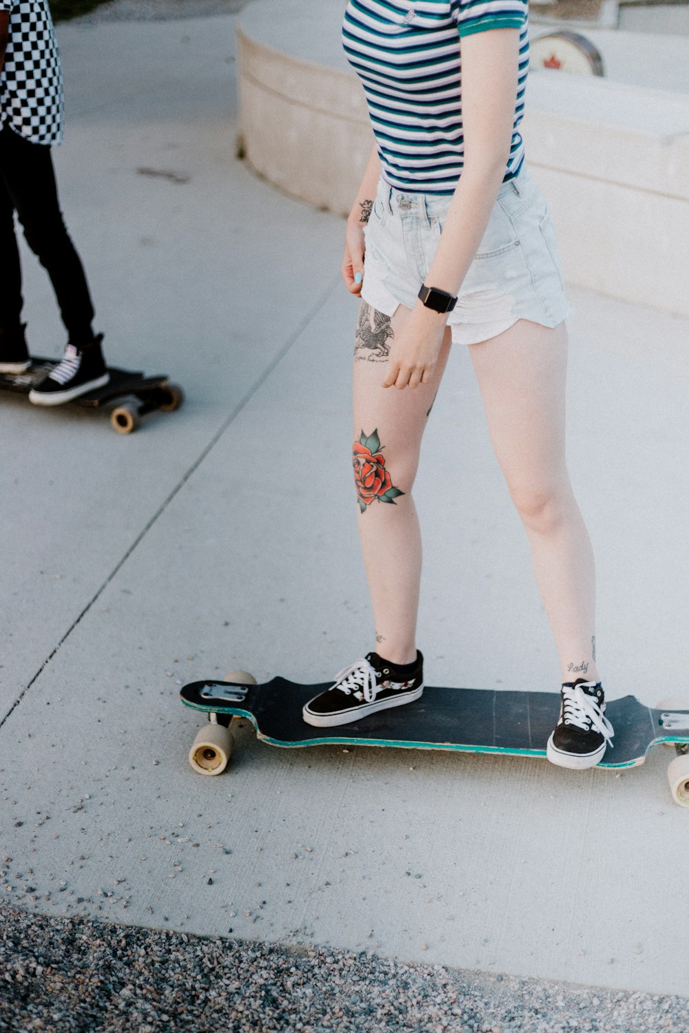 woman riding longboard on pathway