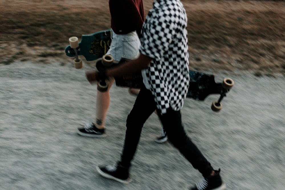 Un couple de personnes qui marchent avec des planches à roulettes