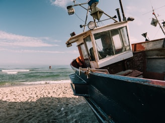 blue fishing boat under blue sky