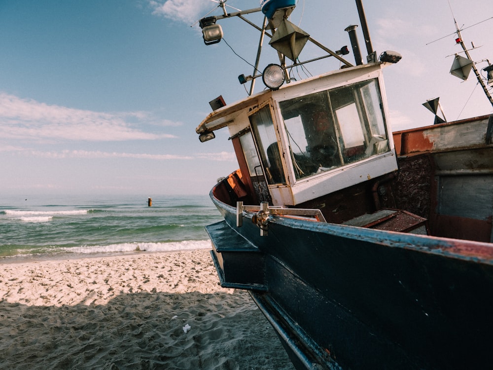 blue fishing boat under blue sky