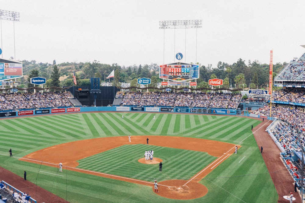 people watching game on stadium during daytime