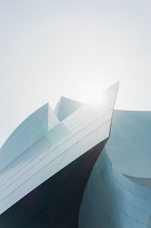 A sleek modern aluminum gate with glass panels reflecting sunlight