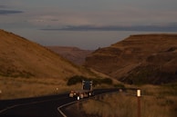 flatbed trailer truck on winding road