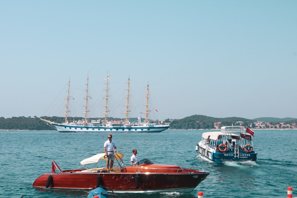 people on red submarine at the sea during daytime