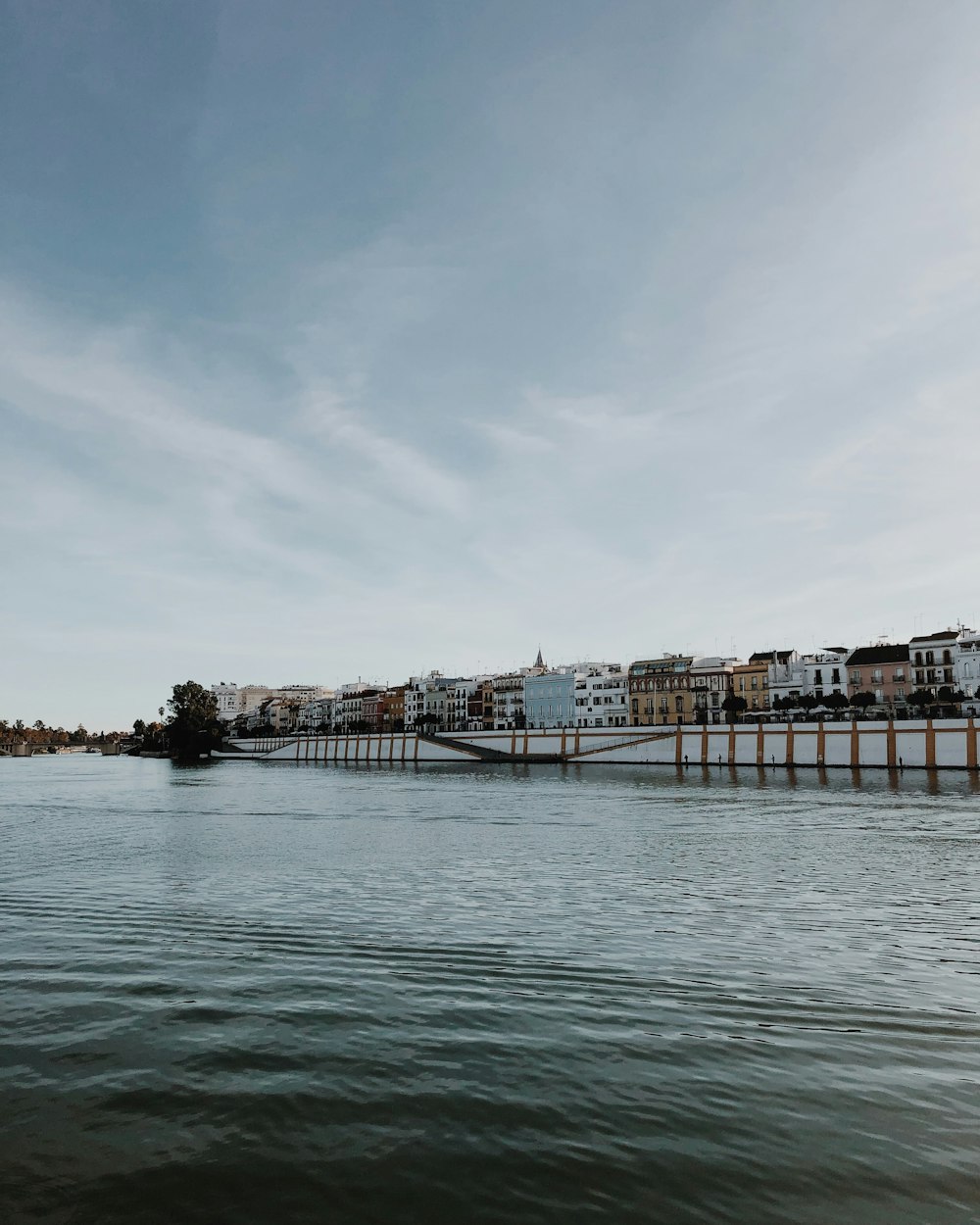 photography of building beside body of water during daytime