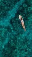 woman wearing white top and panty on body of water