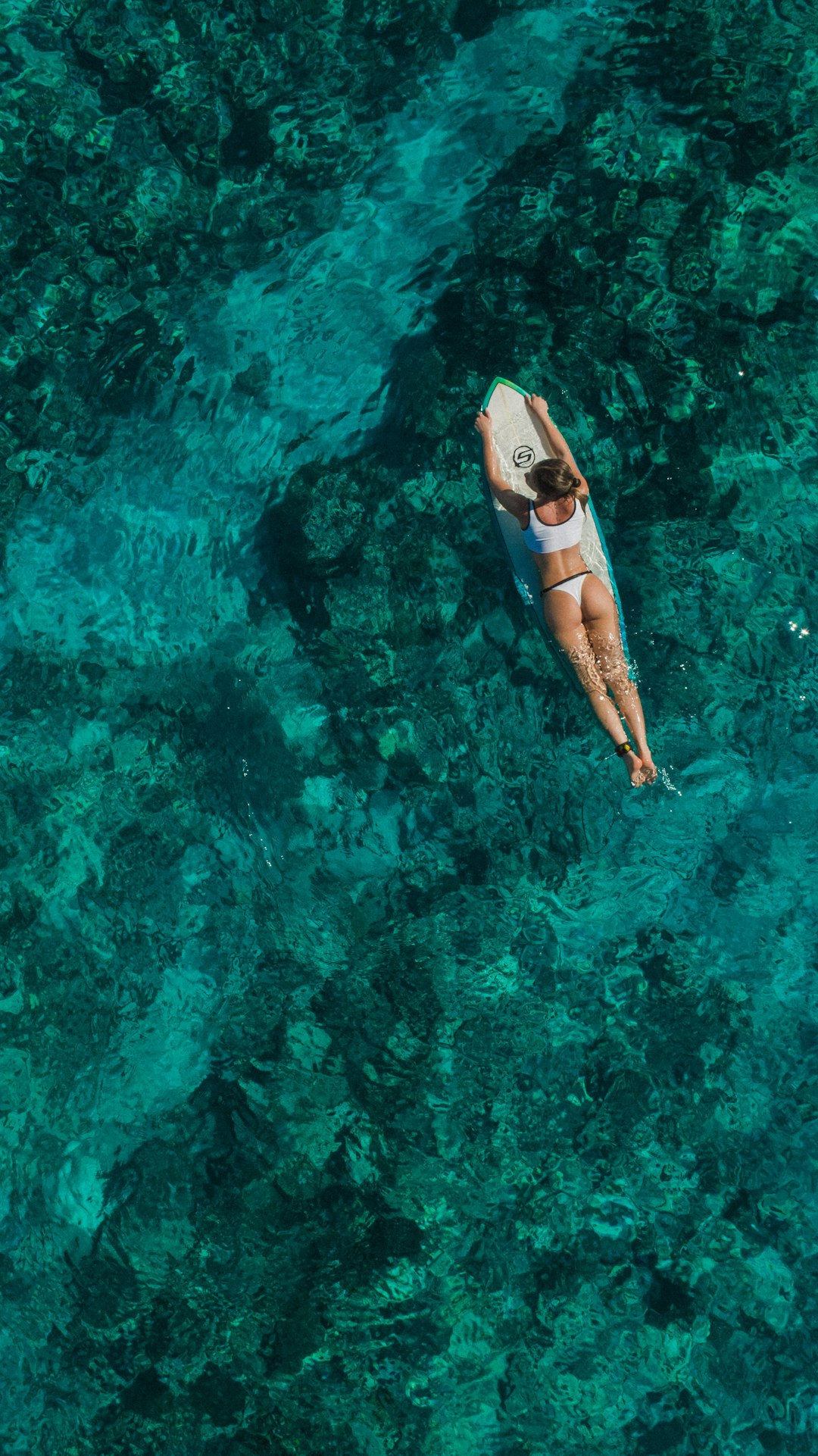 woman wearing white top and panty on body of water