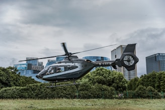 gray and black helicopter flying over the ground