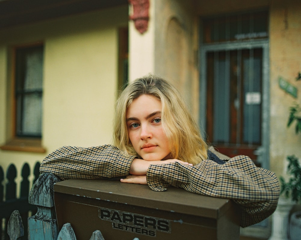 woman standing beside mailbox close-up photography