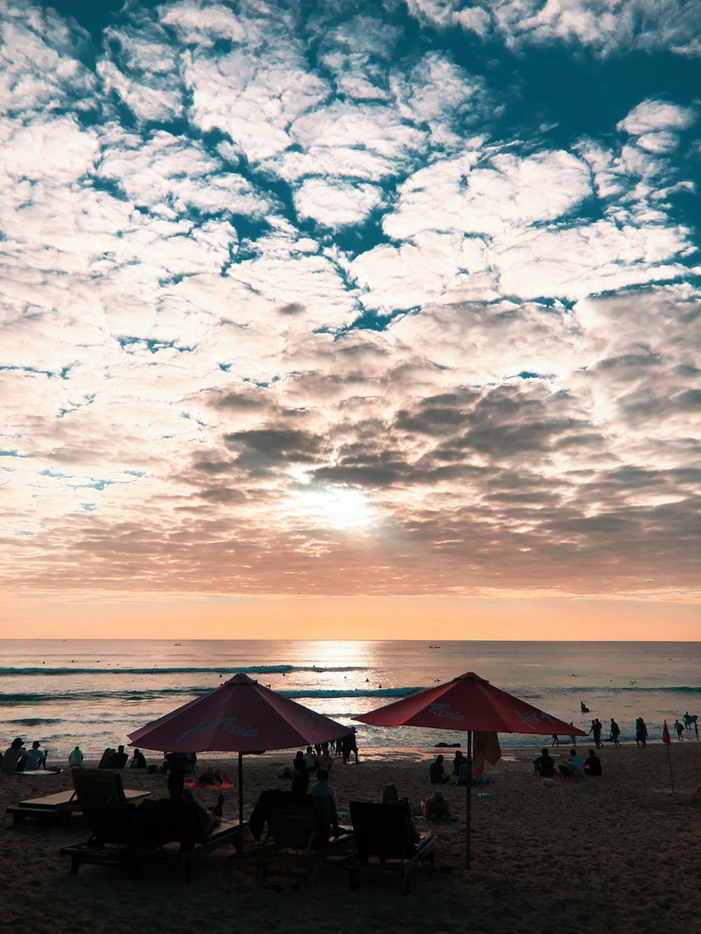 two red patio umbrella in beach during daytime