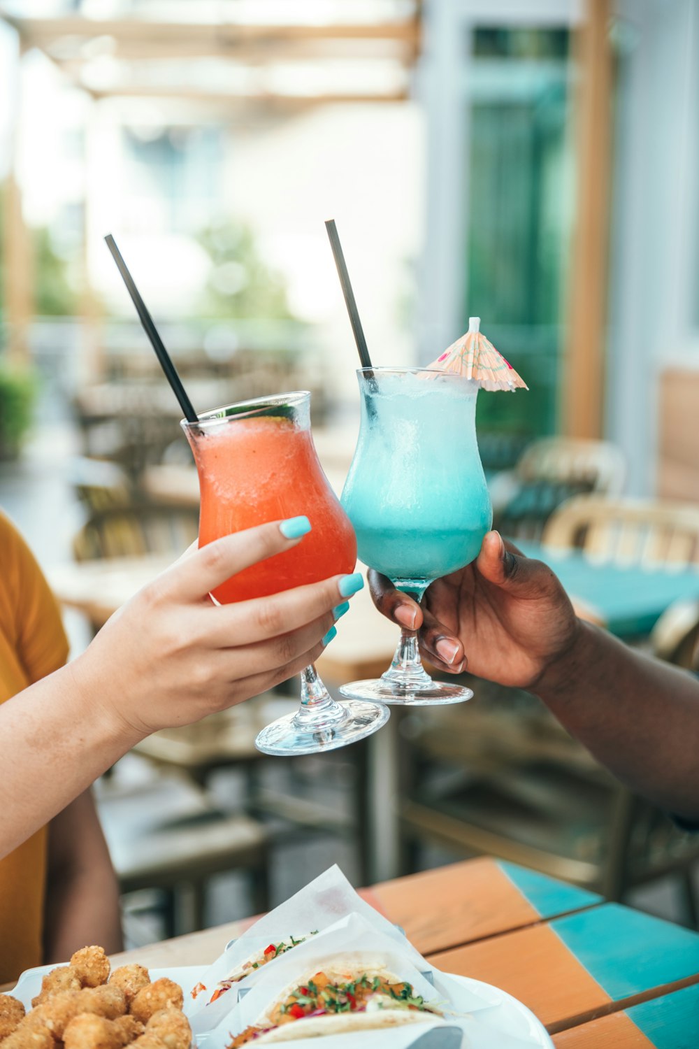 a couple of people that are holding drinks