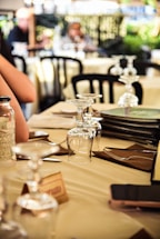 A cozy restaurant table set with menu folders, coasters, and napkin holders arranged neatly.