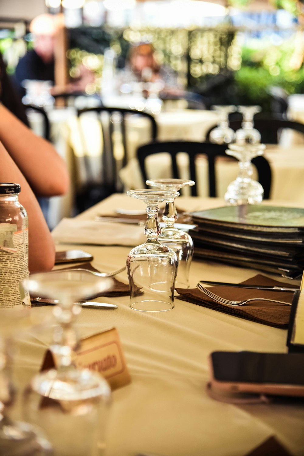 a restaurant table with empty wine glasses on it