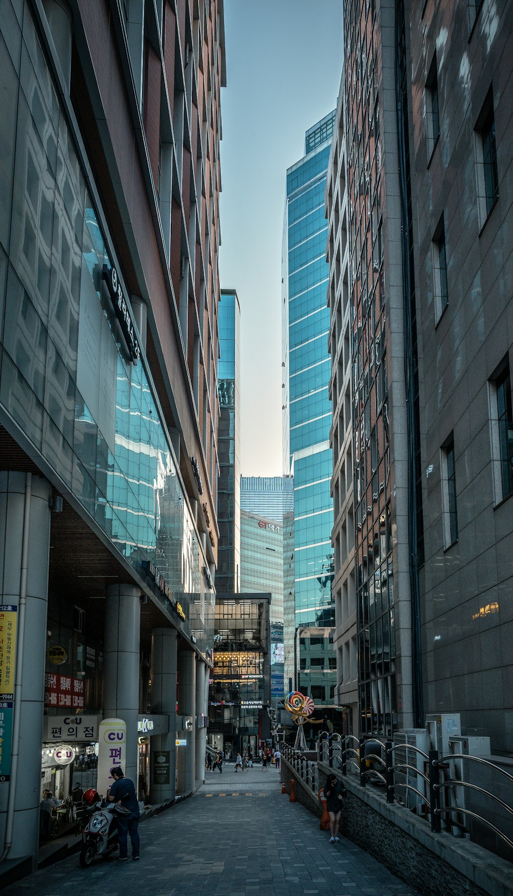 person walking on pathway between buildings