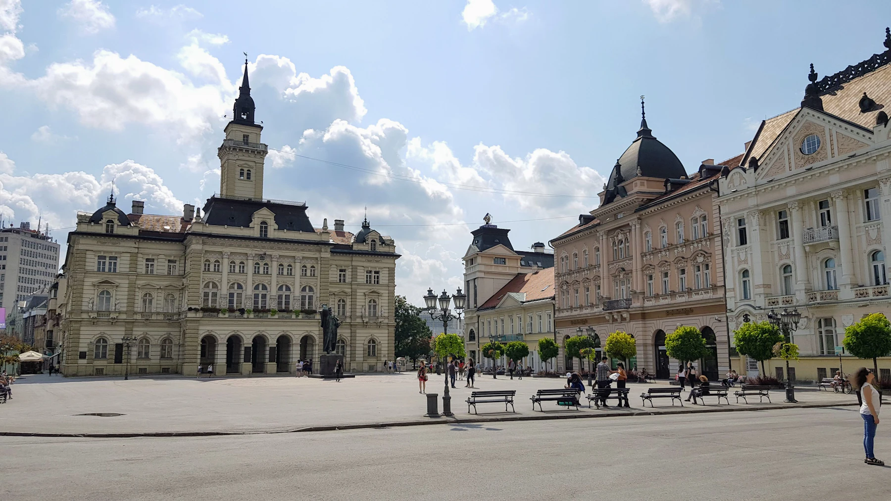 Students and residents walking through sunny Novi Sad, Serbia