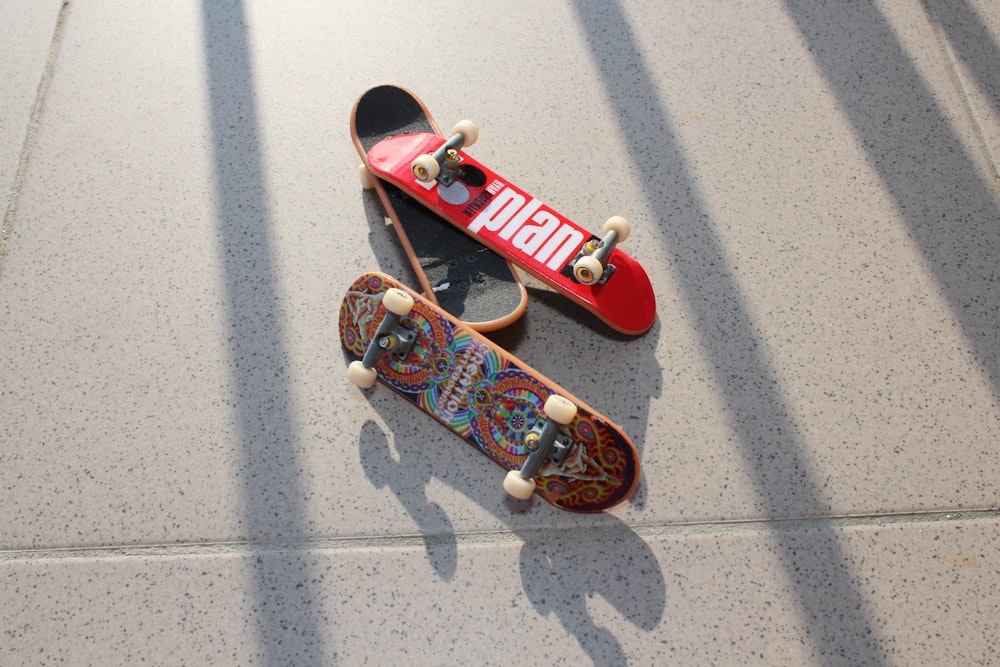 three assorted-color finger skateboard close-up photography