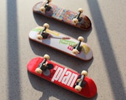 three assorted-color fingerboards