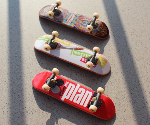 three assorted-color fingerboards