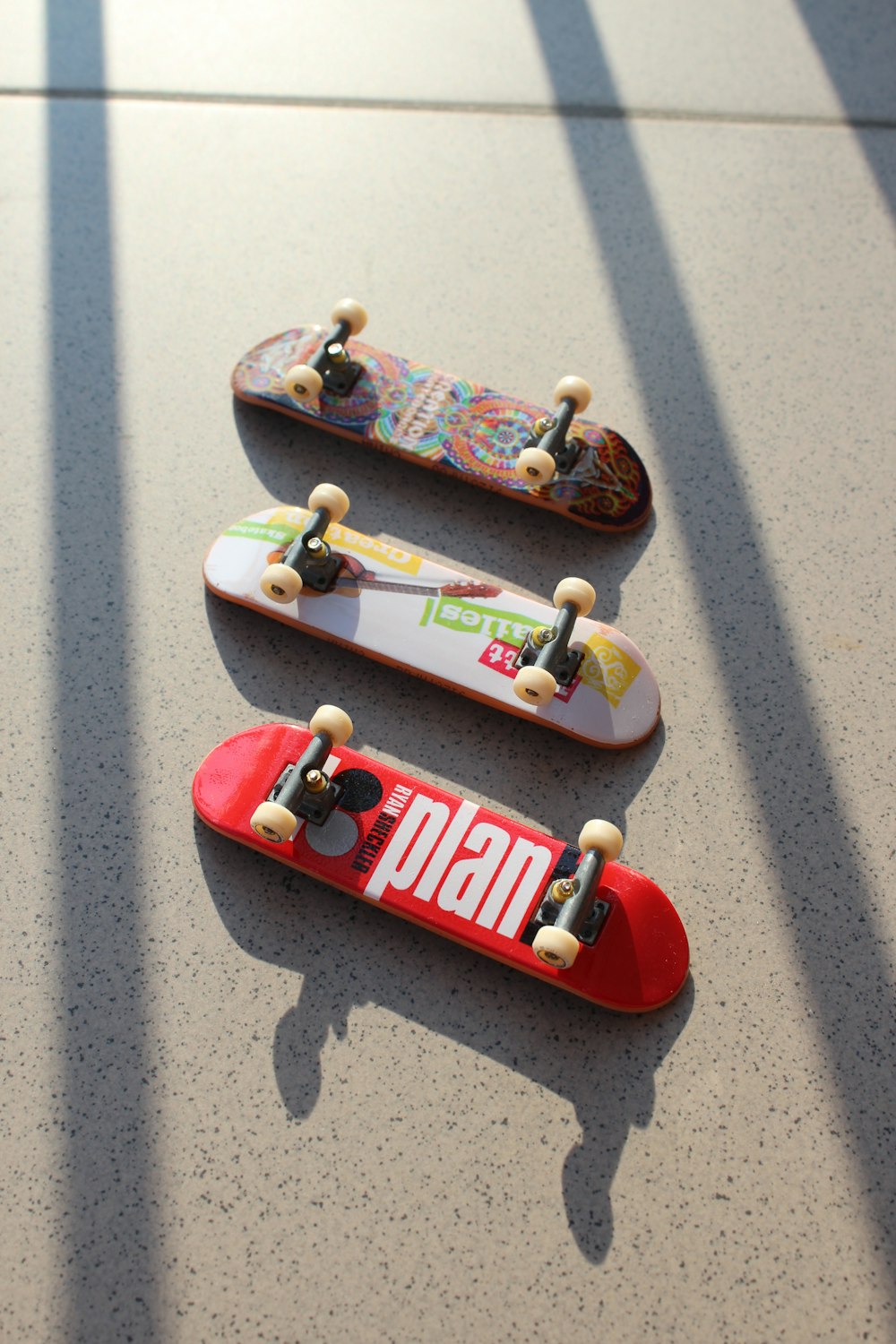 three assorted-color fingerboards