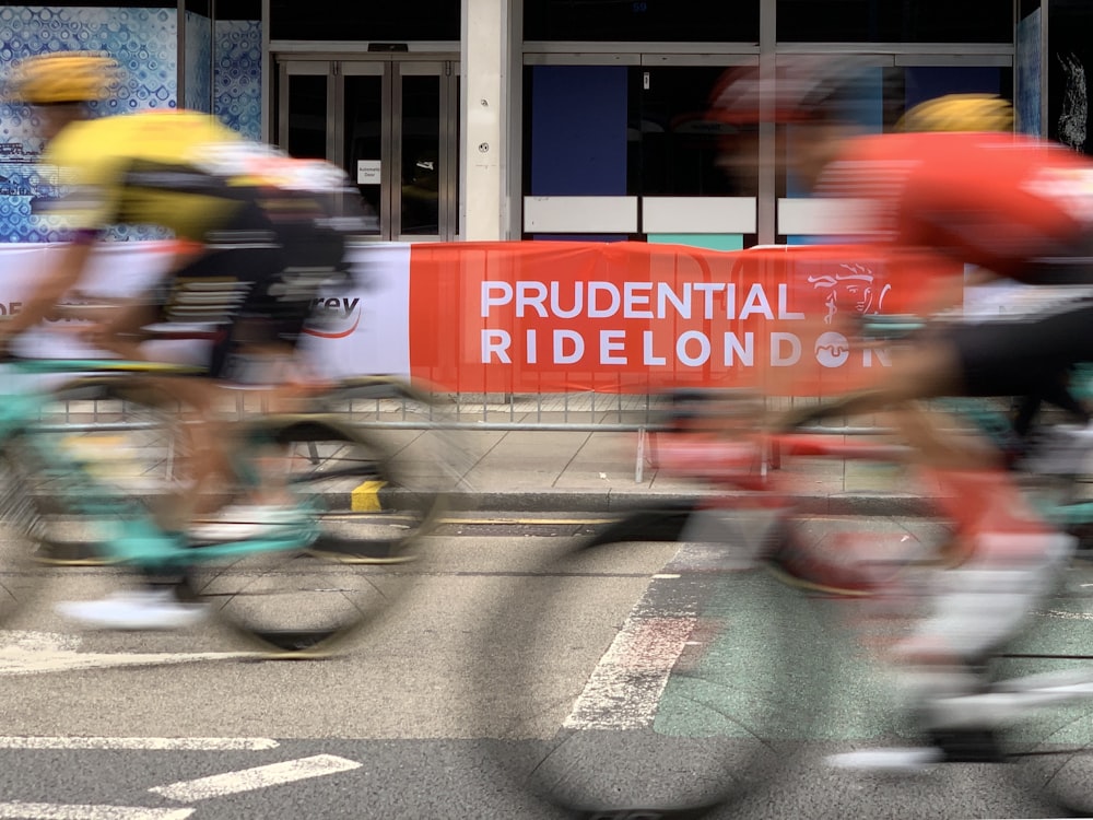 men riding bikes on road near building