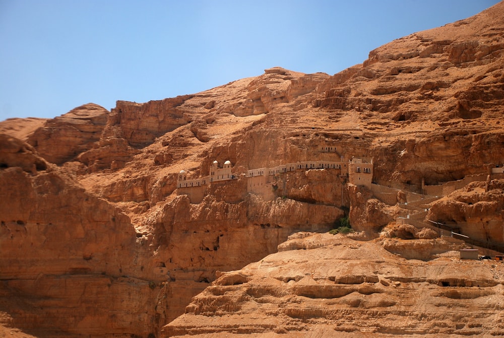 brown rock formations and cave during daytime