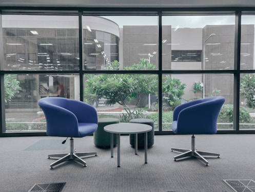 two blue leather rolling chairs