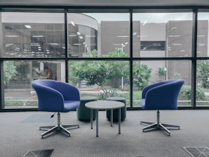 two blue leather rolling chairs