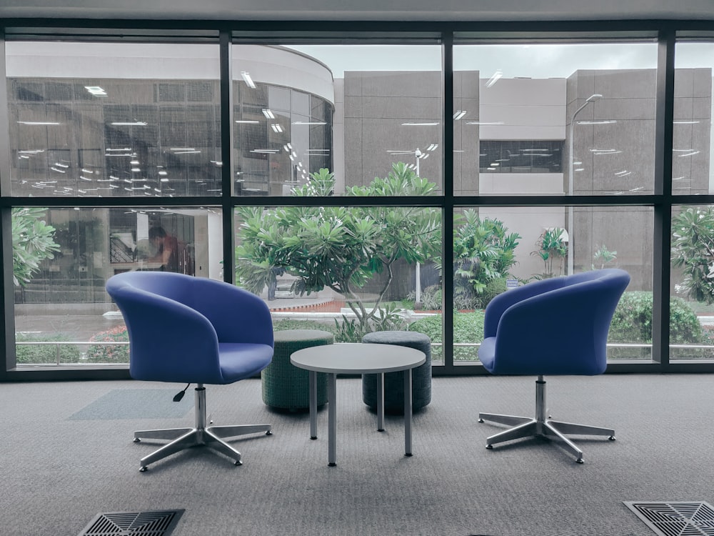 two blue leather rolling chairs