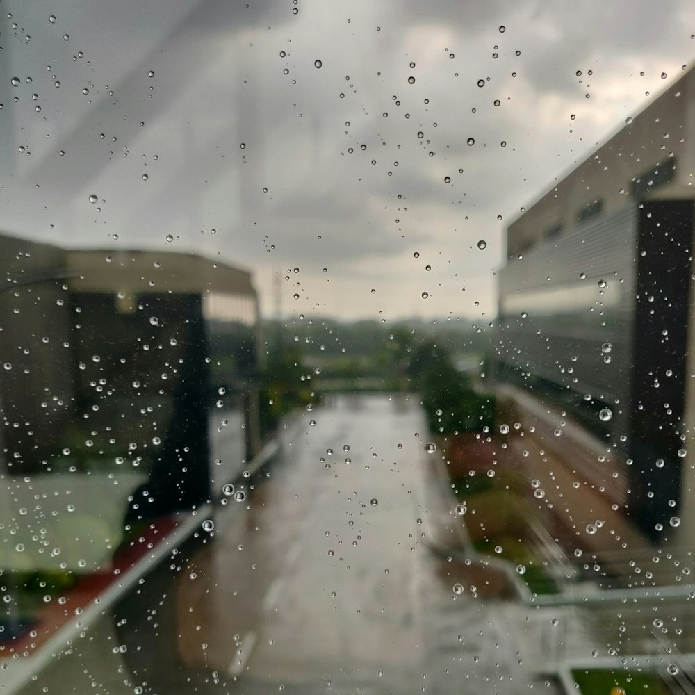 a view of a street through a rain covered window