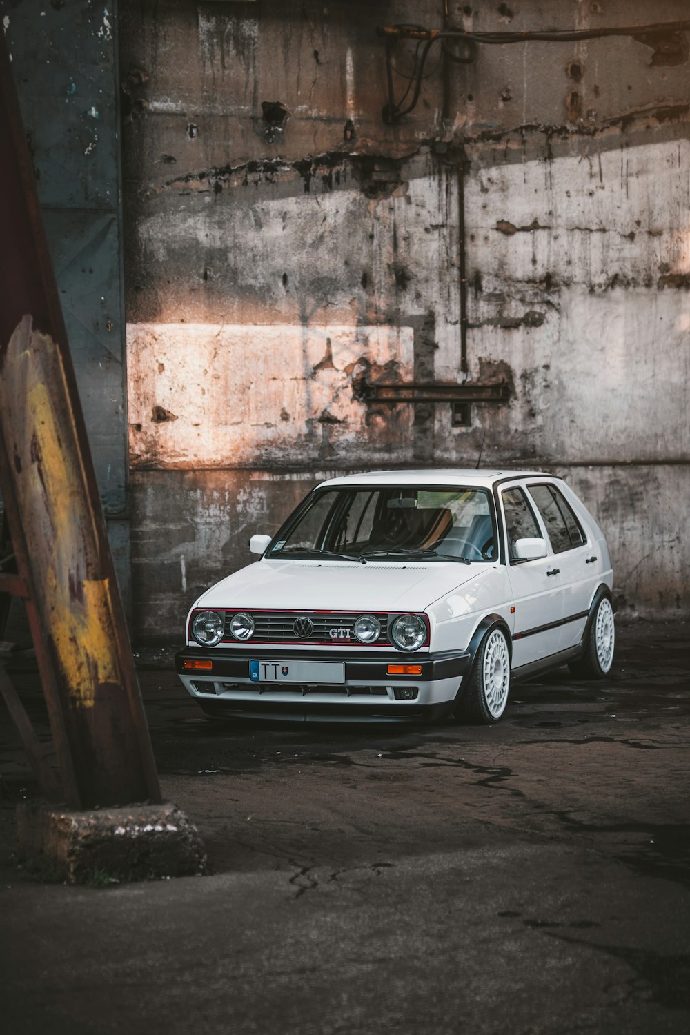 white 5-door hatchback beside white wall