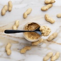 peanut butter with black spoon