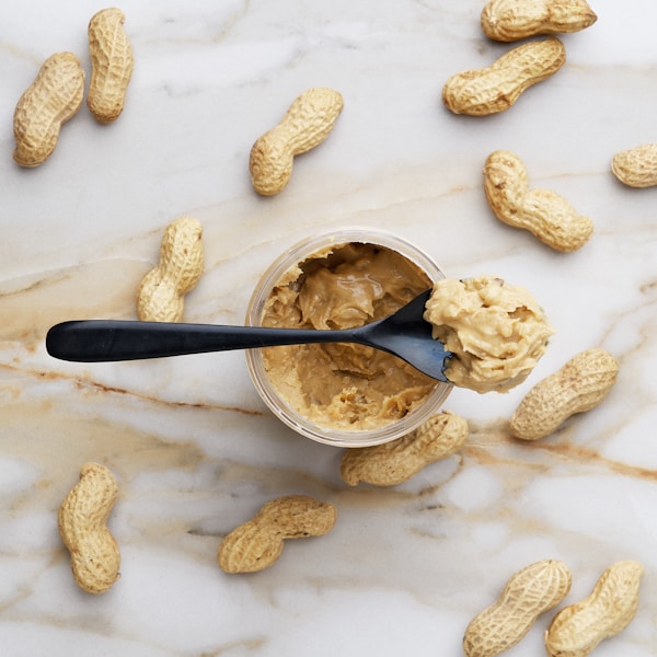 Peanut butter with black spoon