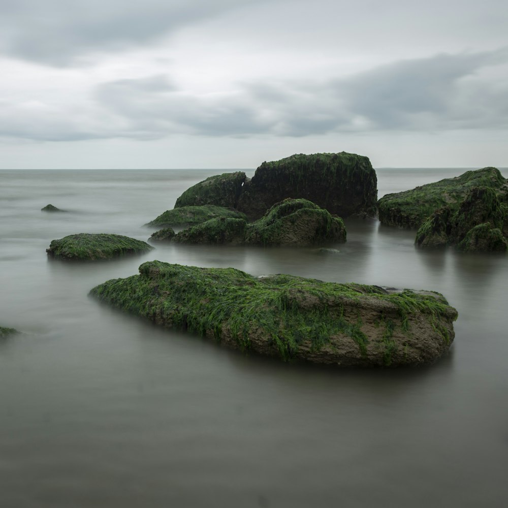 rock formations on sea under white skies