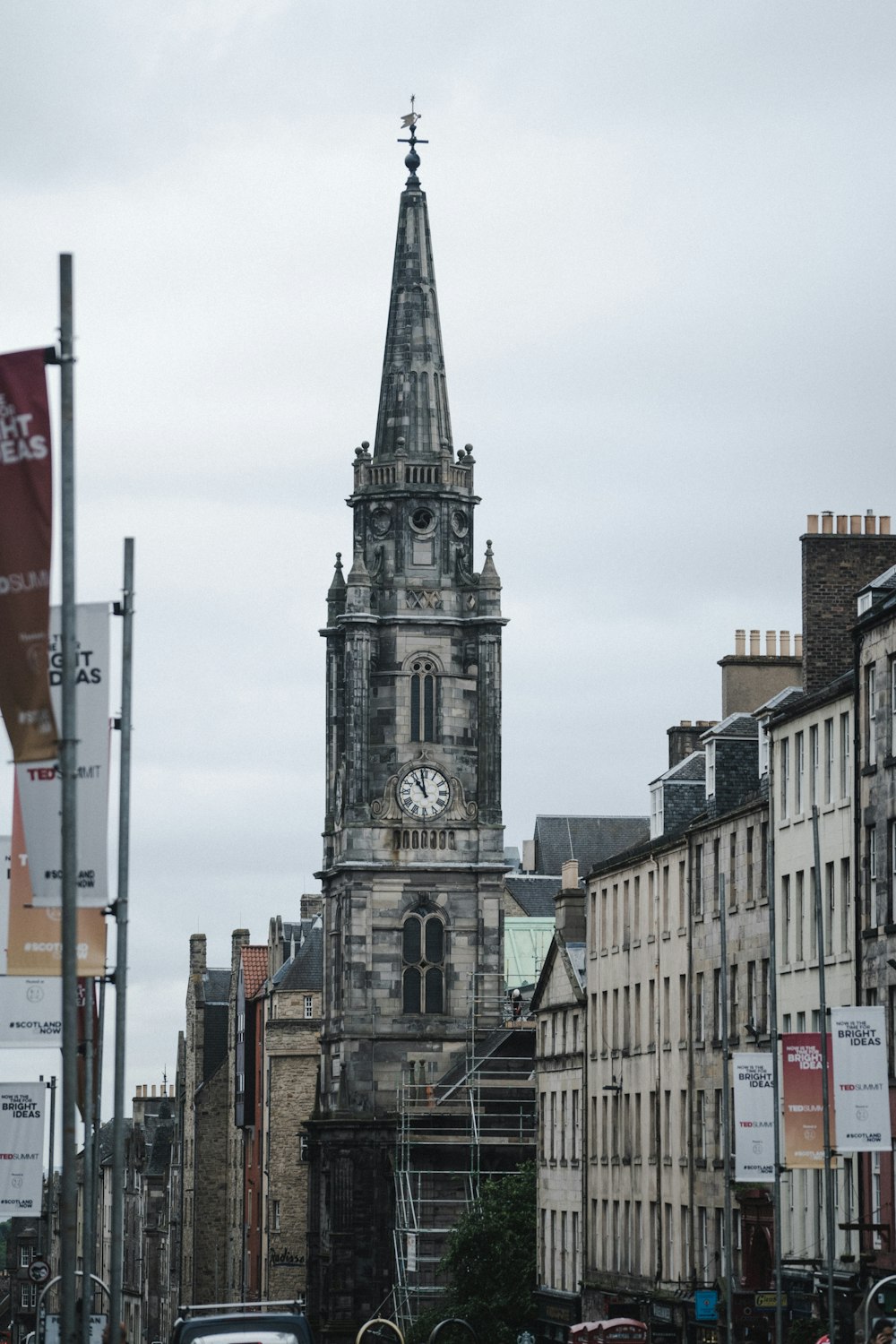 a large clock tower towering over a city street