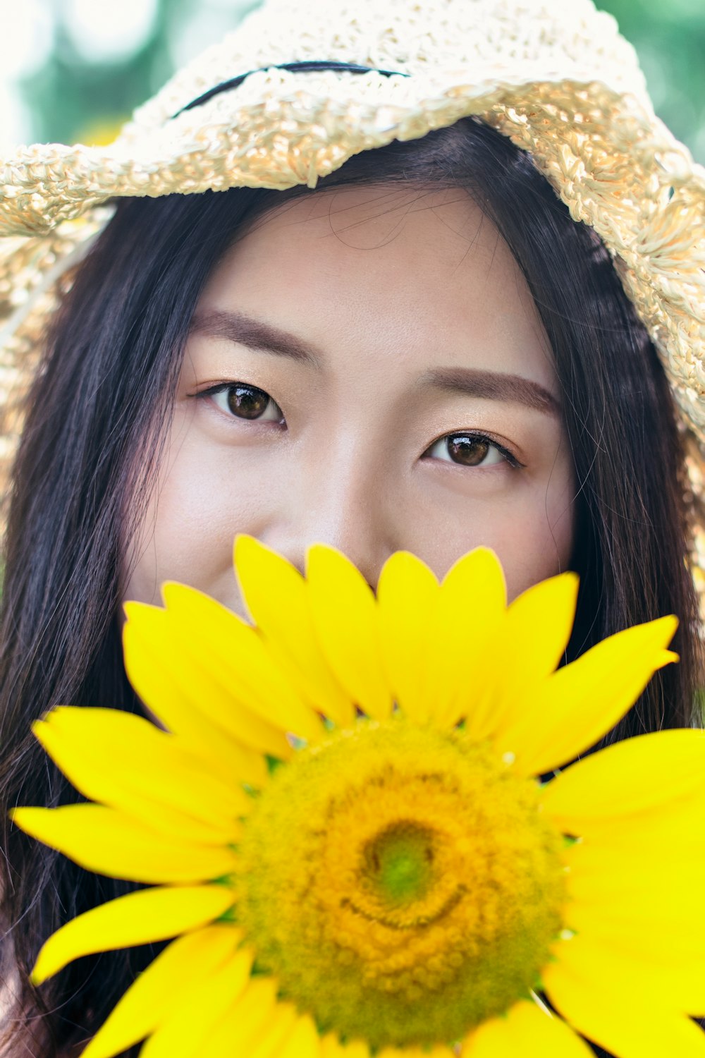 a woman with a sunflower in her hand