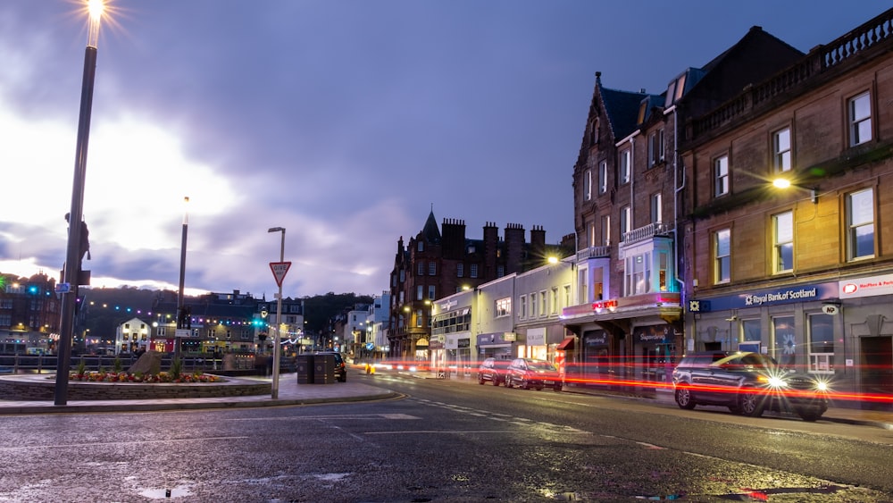 time lapse photo of traffic lights and brown buildings