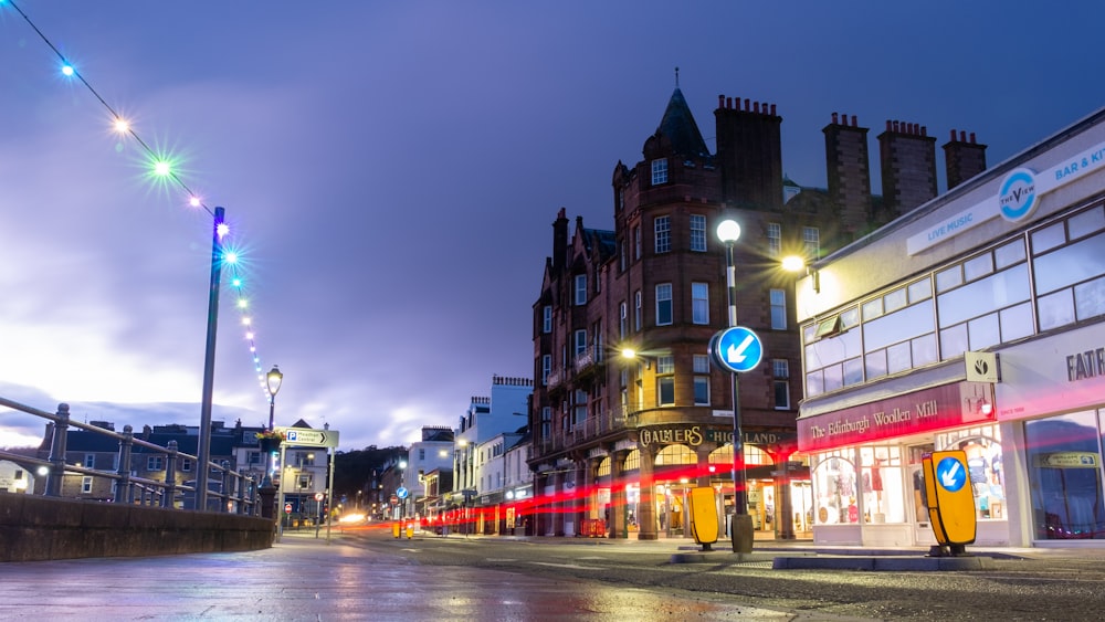 a city street at night with buildings and street lights