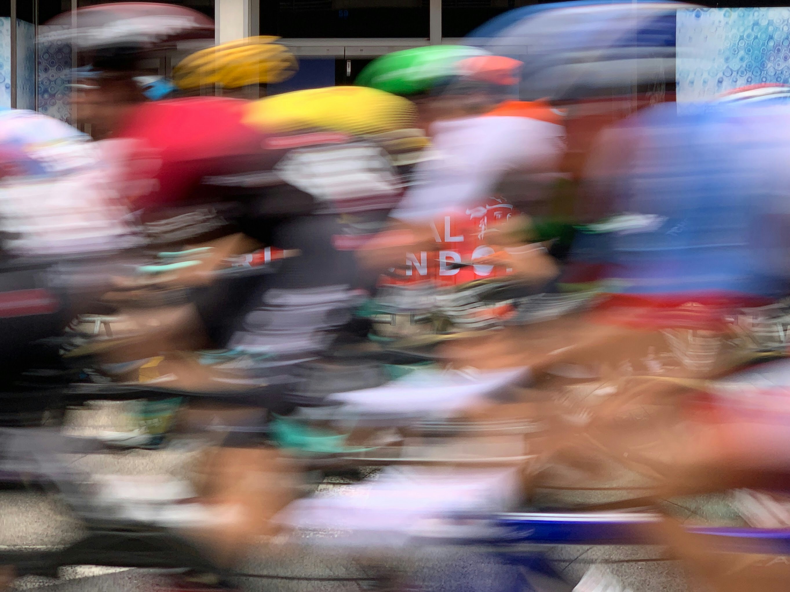 A blurry photo of a group of people riding bicycles