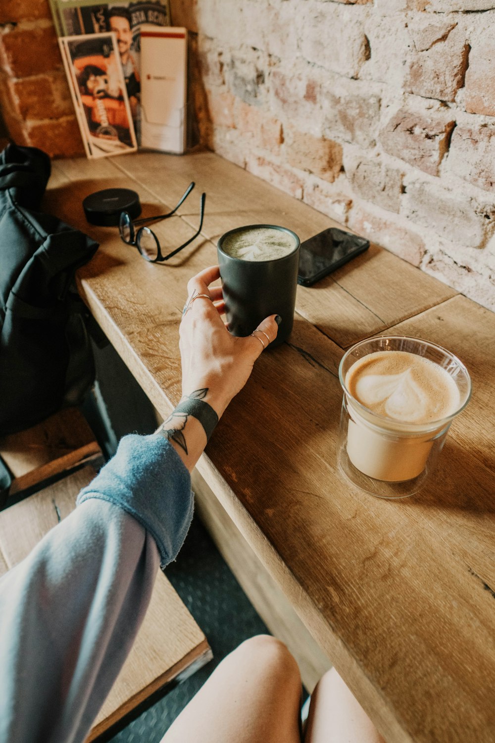 two glasses of coffee on brown table