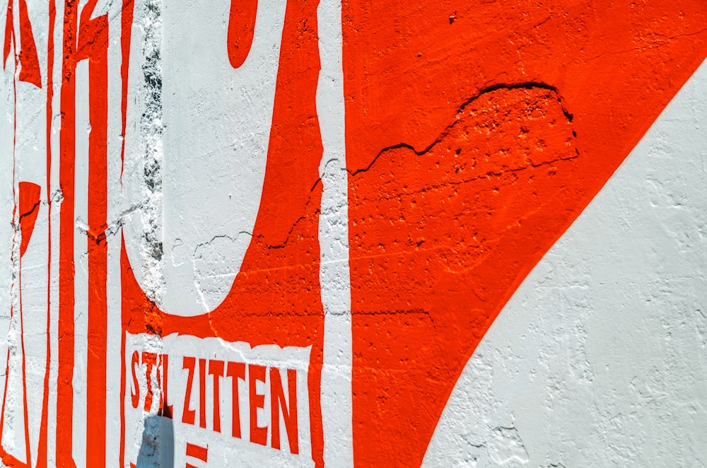 a close up of a street sign on a wall