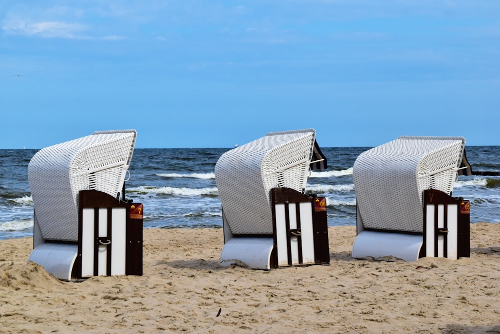 a row of beach chairs sitting on top of a sandy beach