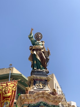 man in green suit statue