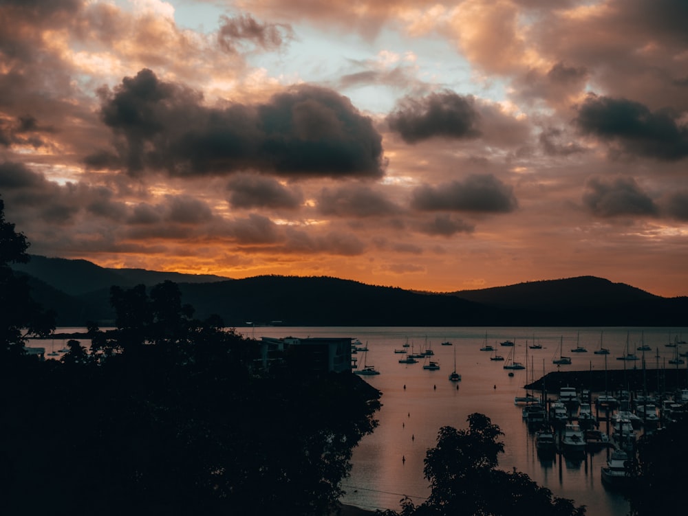 a sunset over a harbor with boats in the water