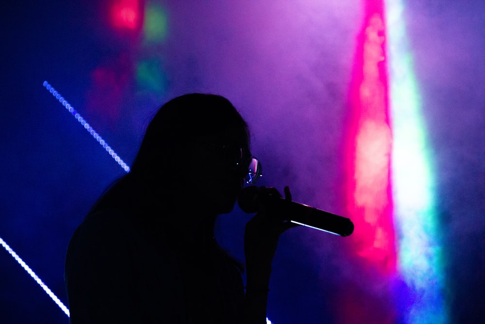 silhouette of person holding microphone