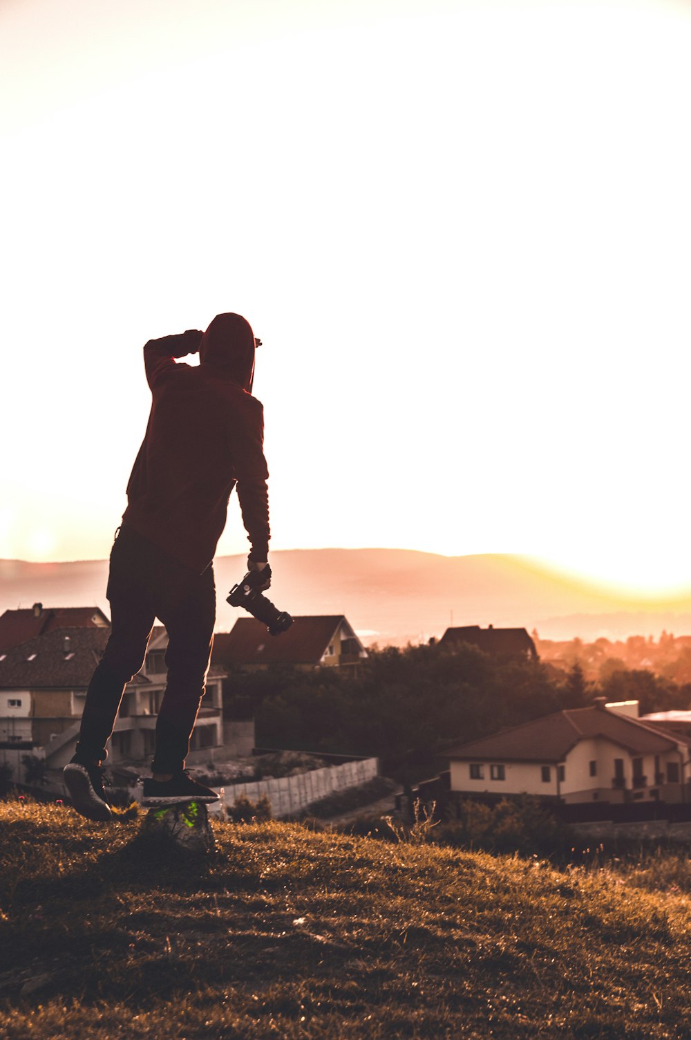 silhouette of man holding camera